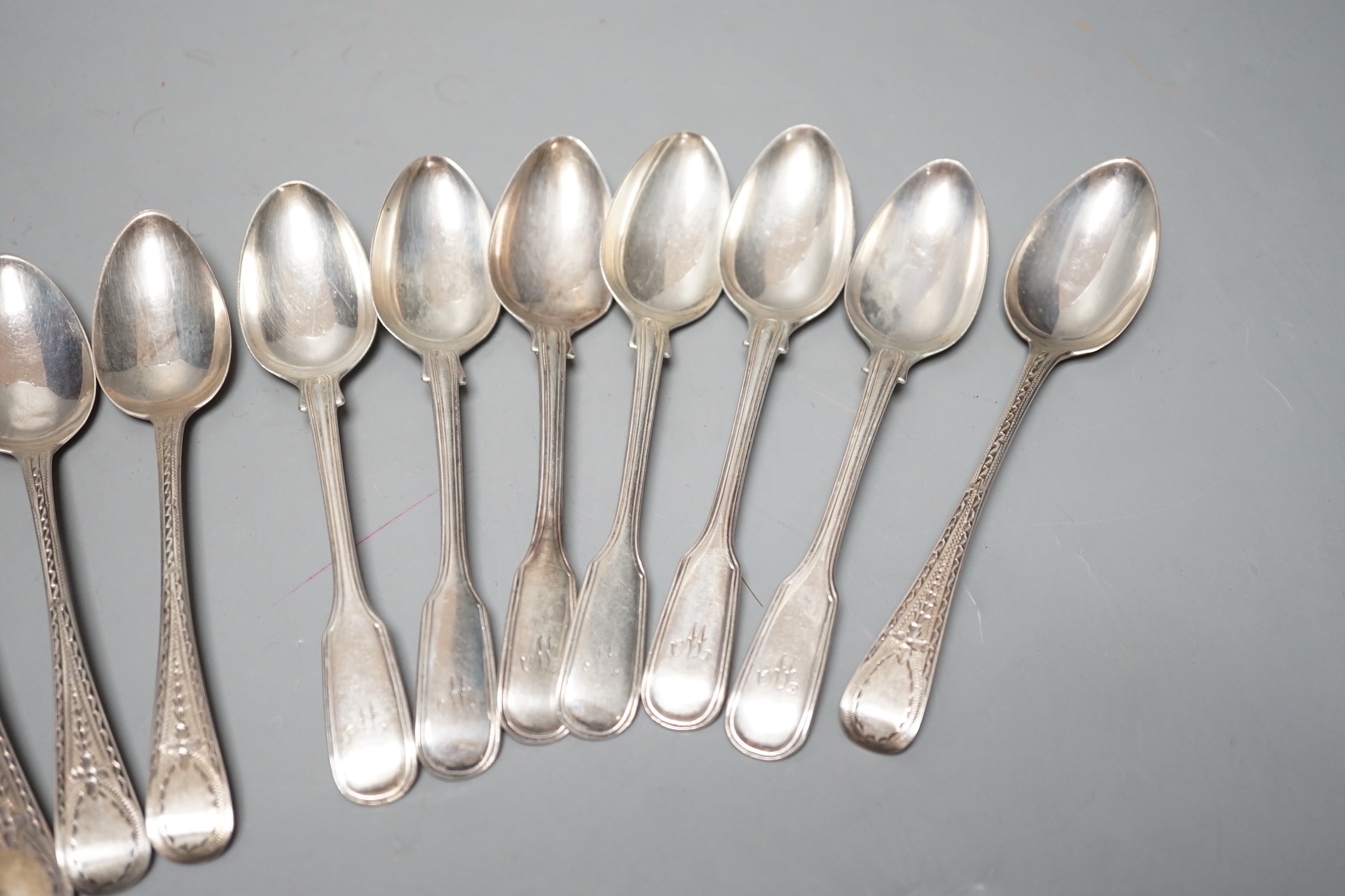 A set of six Victorian silver fiddle and thread pattern teaspoons, London, 1853 and a matched set of six Victorian silver bright cut engraved Old English pattern teaspoons, 9oz.